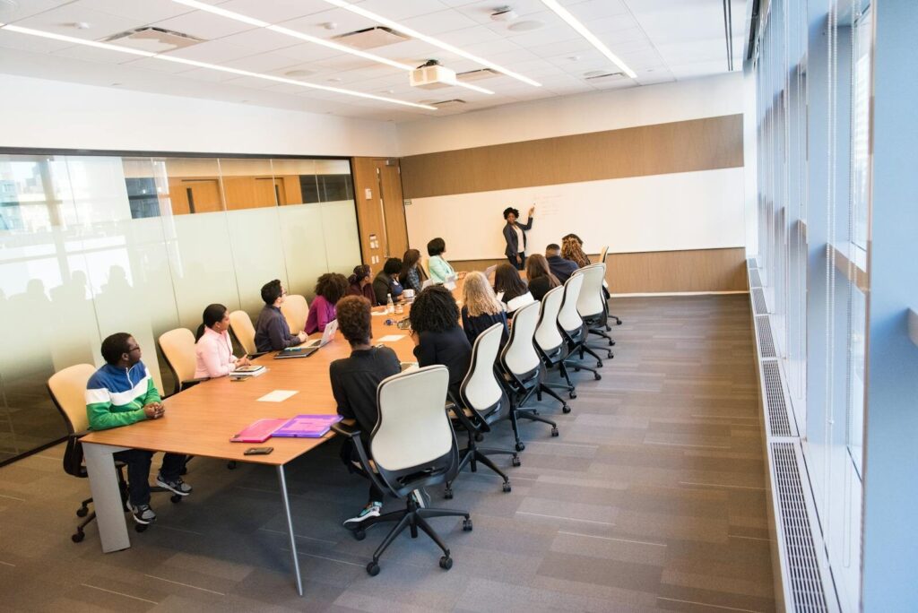 A diverse group actively collaborating in a bright, modern conference room setting.